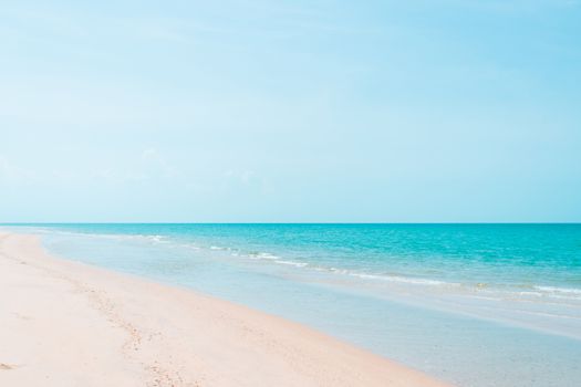 Tropical nature clean beach and white sand in summer with sun light blue sky and bokeh abstract  background.