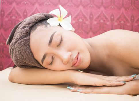 Beautiful asian woman with closed eyes relaxing in spa salon