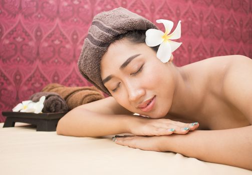 Beautiful woman with closed eyes relaxing in spa salon