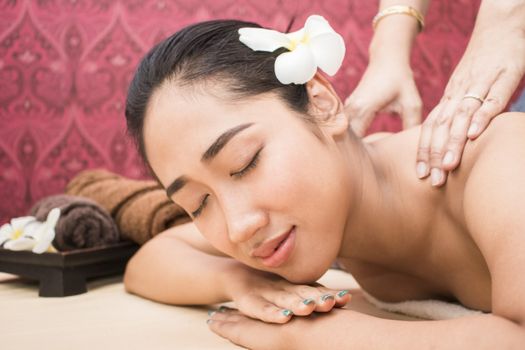 happy attractive asian woman relaxing and having massage in spa salon