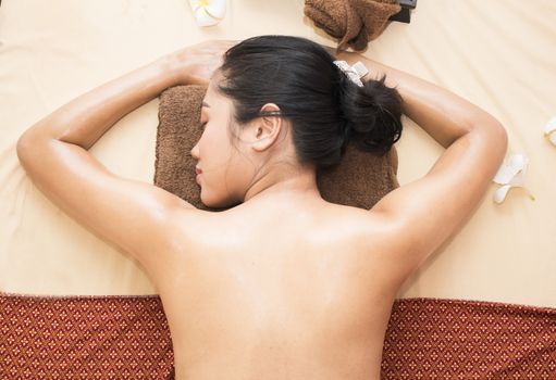 Young beautiful asian woman relaxing in spa salon