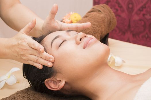 Young woman getting thai massage in spa