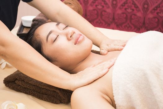 Young asian woman getting thai massage in spa