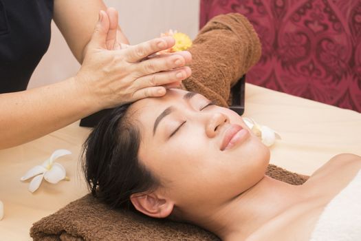 Young woman getting thai massage in spa