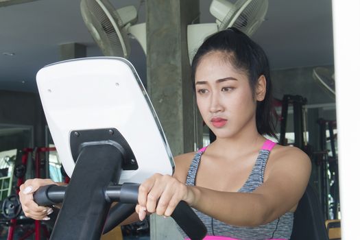 Asian fitness woman doing exercises in the gym, Healthy Lifestyle Concept