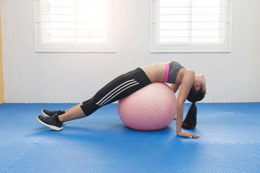 Woman with gym ball in home gym,Healthy concept