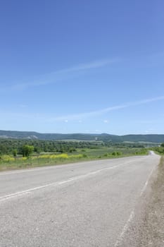 Beautiful summer landscape with road to mountains