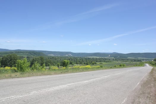 Beautiful summer landscape with road to mountains