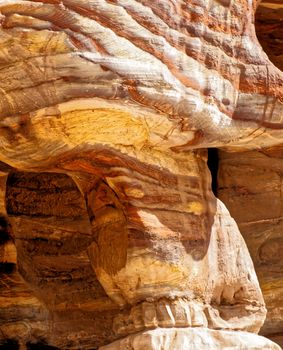 Laminated sandstone in Petra, Jordan, with strong red, yellow, orange and brown colours, middle east