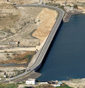Wadi Mujib dam with a road for public transport in Jordan, middle east