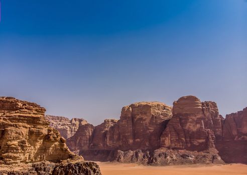Aerial view, taken with the drone, of rock formations and monolithic mountains in the desert of Wadi Rum, Jordan, middle east