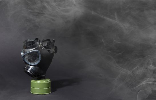 Vintage gasmask isolated on black background - White smoke in the room