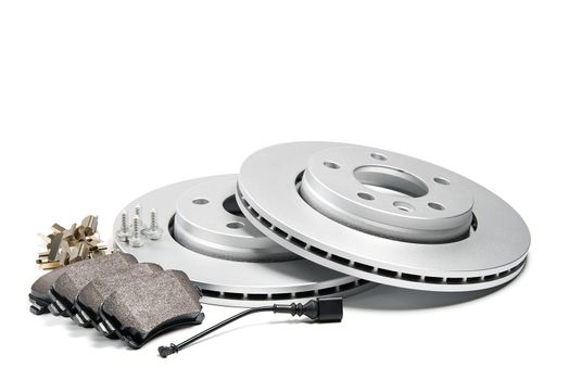 brand new brake discs and brake pad set for car. isolated on white with copy space
