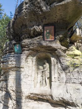 Relief Flight into Egypt sculpted to the sandstone rock in 1740 by joiner Franz Schier in forest near small village Marenicky in luzicke hory, Lusatian Mountains, early spring.