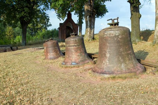 Church bells laid in the landscape in Wambierzyce city in Poland