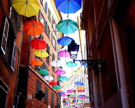 Genova, Italy - 06/25/2020:Bright abstract background of jumble of rainbow colored umbrellas over the city celebrating gay pride