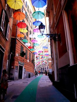 Genova, Italy - 06/25/2020:Bright abstract background of jumble of rainbow colored umbrellas over the city celebrating gay pride