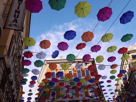 Genova, Italy - 06/25/2020:Bright abstract background of jumble of rainbow colored umbrellas over the city celebrating gay pride