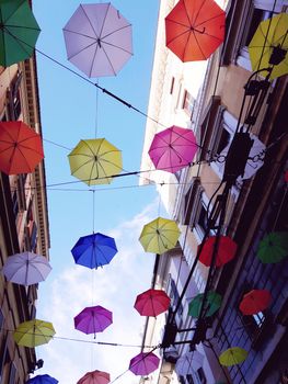 Genova, Italy - 06/25/2020:Bright abstract background of jumble of rainbow colored umbrellas over the city celebrating gay pride