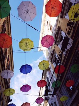 Genova, Italy - 06/25/2020:Bright abstract background of jumble of rainbow colored umbrellas over the city celebrating gay pride
