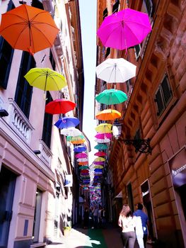 Genova, Italy - 06/25/2020:Bright abstract background of jumble of rainbow colored umbrellas over the city celebrating gay pride