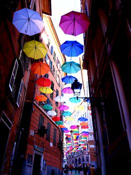 Genova, Italy - 06/25/2020:Bright abstract background of jumble of rainbow colored umbrellas over the city celebrating gay pride