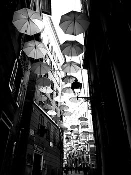 Genova, Italy - 06/25/2020:Bright abstract background of jumble of rainbow colored umbrellas over the city celebrating gay pride