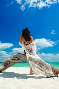 Young woman on the tropical white sand beach