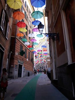 Genova, Italy - 06/25/2020:Bright abstract background of jumble of rainbow colored umbrellas over the city celebrating gay pride