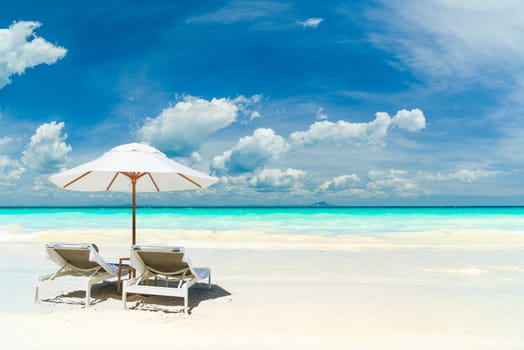 Sunbeds and umbrella at the tropical beach