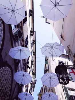 Genova, Italy - 06/01/2020: Bright abstract background of jumble of rainbow colored umbrellas over the city celebrating gay pride