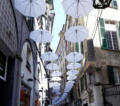 Genova, Italy - 06/01/2020: Bright abstract background of jumble of rainbow colored umbrellas over the city celebrating gay pride