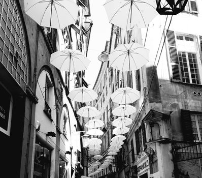 Genova, Italy - 06/01/2020: Bright abstract background of jumble of rainbow colored umbrellas over the city celebrating gay pride