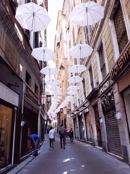 Genova, Italy - 06/01/2020: Bright abstract background of jumble of rainbow colored umbrellas over the city celebrating gay pride