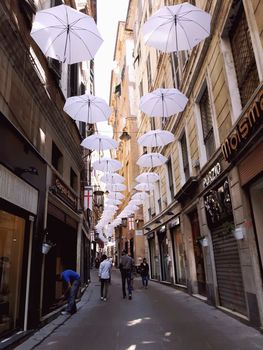 Genova, Italy - 06/01/2020: Bright abstract background of jumble of rainbow colored umbrellas over the city celebrating gay pride