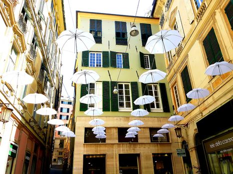 Genova, Italy - 06/01/2020: Bright abstract background of jumble of rainbow colored umbrellas over the city celebrating gay pride