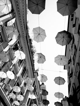 Genova, Italy - 06/01/2020: Bright abstract background of jumble of rainbow colored umbrellas over the city celebrating gay pride