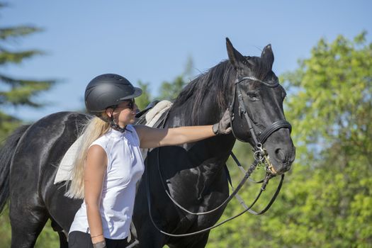  riding girl are training her black horse