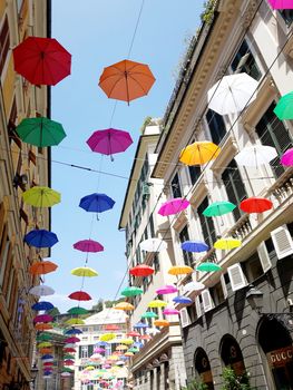 Genova, Italy - 06/01/2020: Bright abstract background of jumble of rainbow colored umbrellas over the city celebrating gay pride