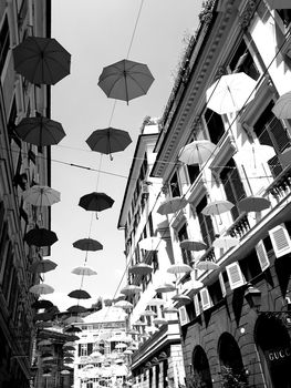 Genova, Italy - 06/01/2020: Bright abstract background of jumble of rainbow colored umbrellas over the city celebrating gay pride