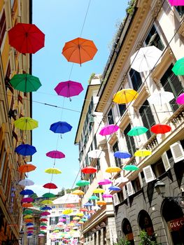 Genova, Italy - 06/01/2020: Bright abstract background of jumble of rainbow colored umbrellas over the city celebrating gay pride
