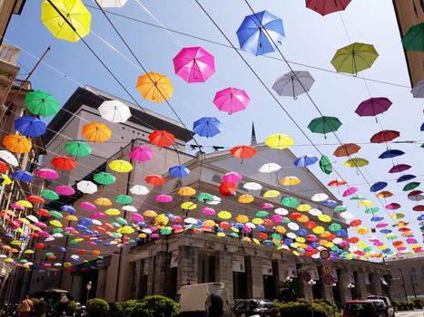 Genova, Italy - 06/01/2020: Bright abstract background of jumble of rainbow colored umbrellas over the city celebrating gay pride