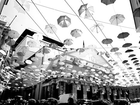 Genova, Italy - 06/01/2020: Bright abstract background of jumble of rainbow colored umbrellas over the city celebrating gay pride