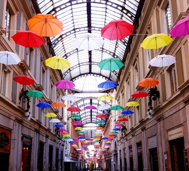 Genova, Italy - 06/01/2020: Bright abstract background of jumble of rainbow colored umbrellas over the city celebrating gay pride