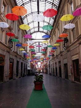 Genova, Italy - 06/01/2020: Bright abstract background of jumble of rainbow colored umbrellas over the city celebrating gay pride