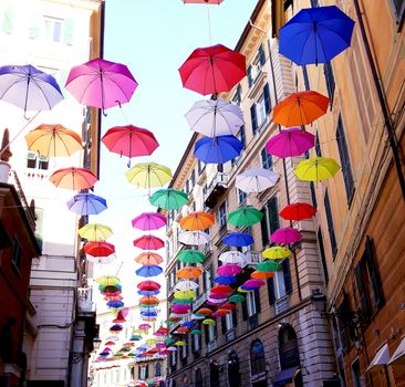 Genova, Italy - 06/01/2020: Bright abstract background of jumble of rainbow colored umbrellas over the city celebrating gay pride