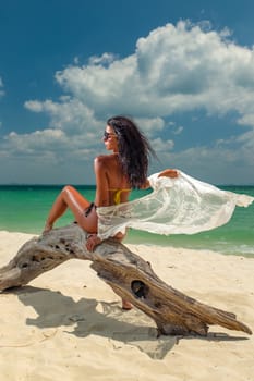 Young woman on the tropical white sand beach