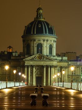 River Seine with Pont des Arts and Institut de France at night in Paris, France