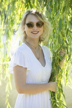 beautiful young blond woman resting in a garden