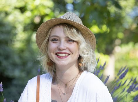 beautiful young blond woman resting in a garden